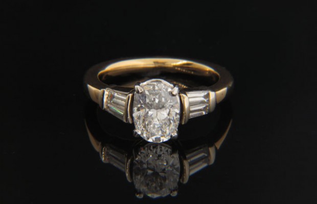 18k Gold Cathedral Engagement Ring featuring an Oval Brilliant Cut Stone